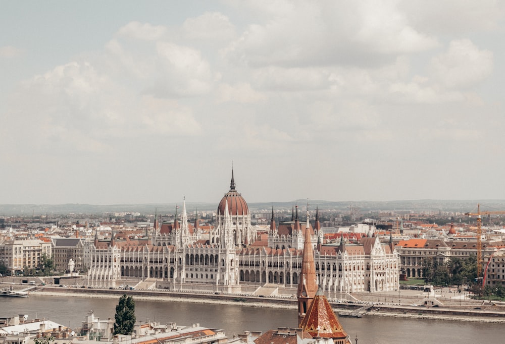 white and orange dome building near river