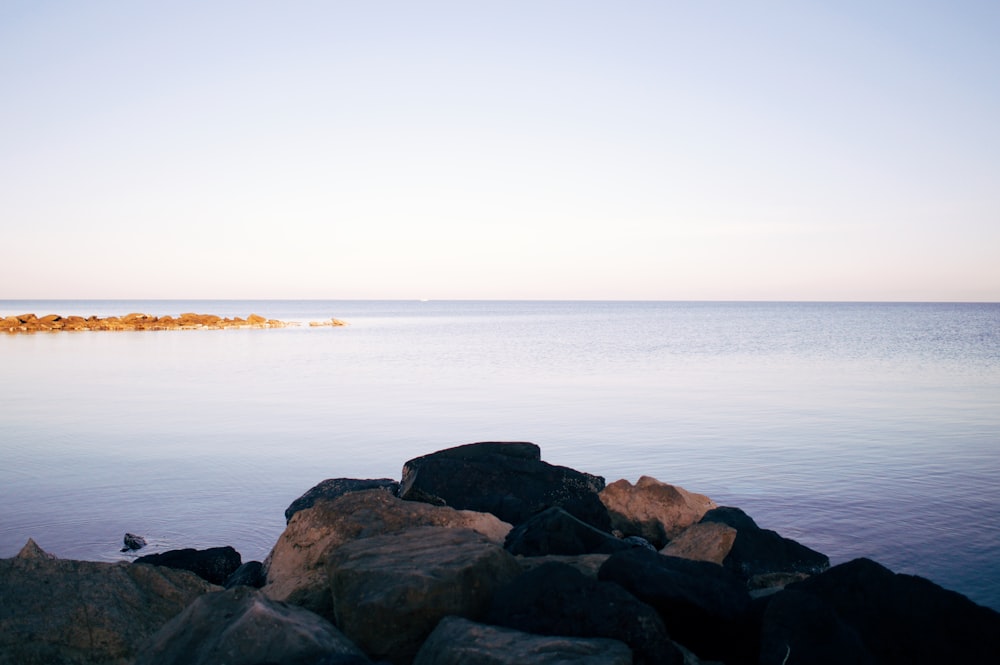 rocks beside body of water