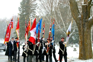 A group of veterans gathered outdoors during a commemorative ceremony.