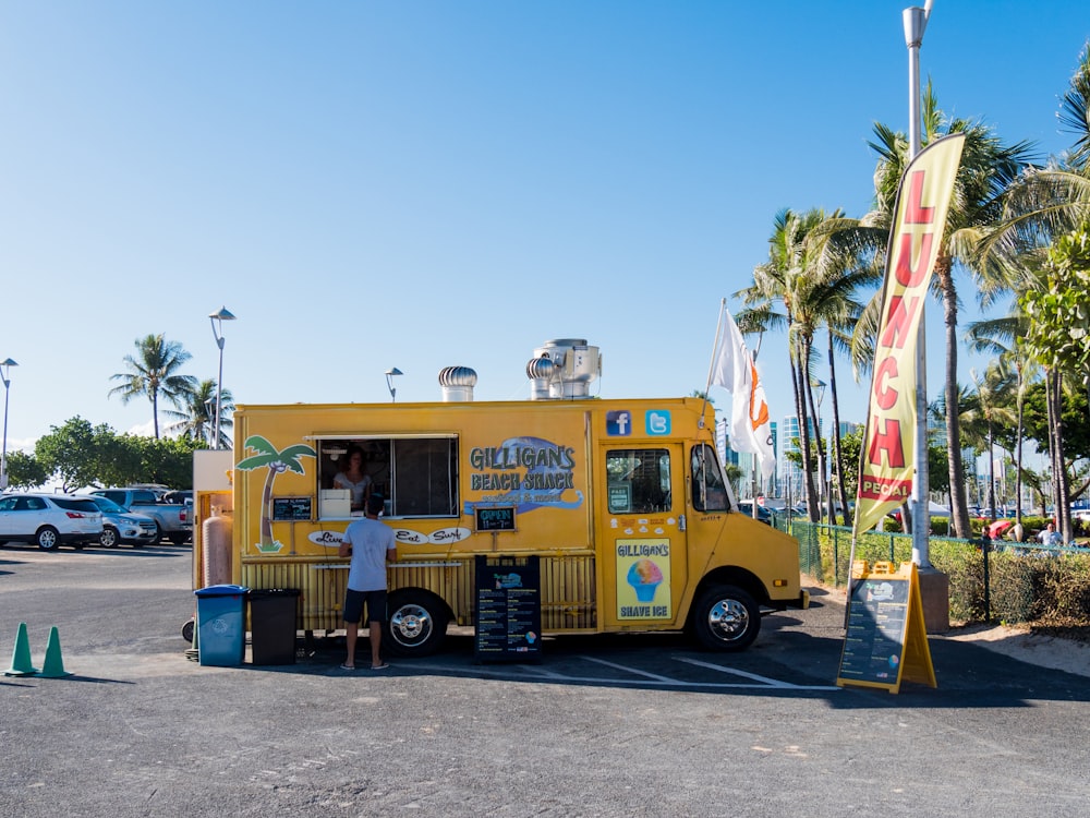 yellow multi-stop truck in parking lot