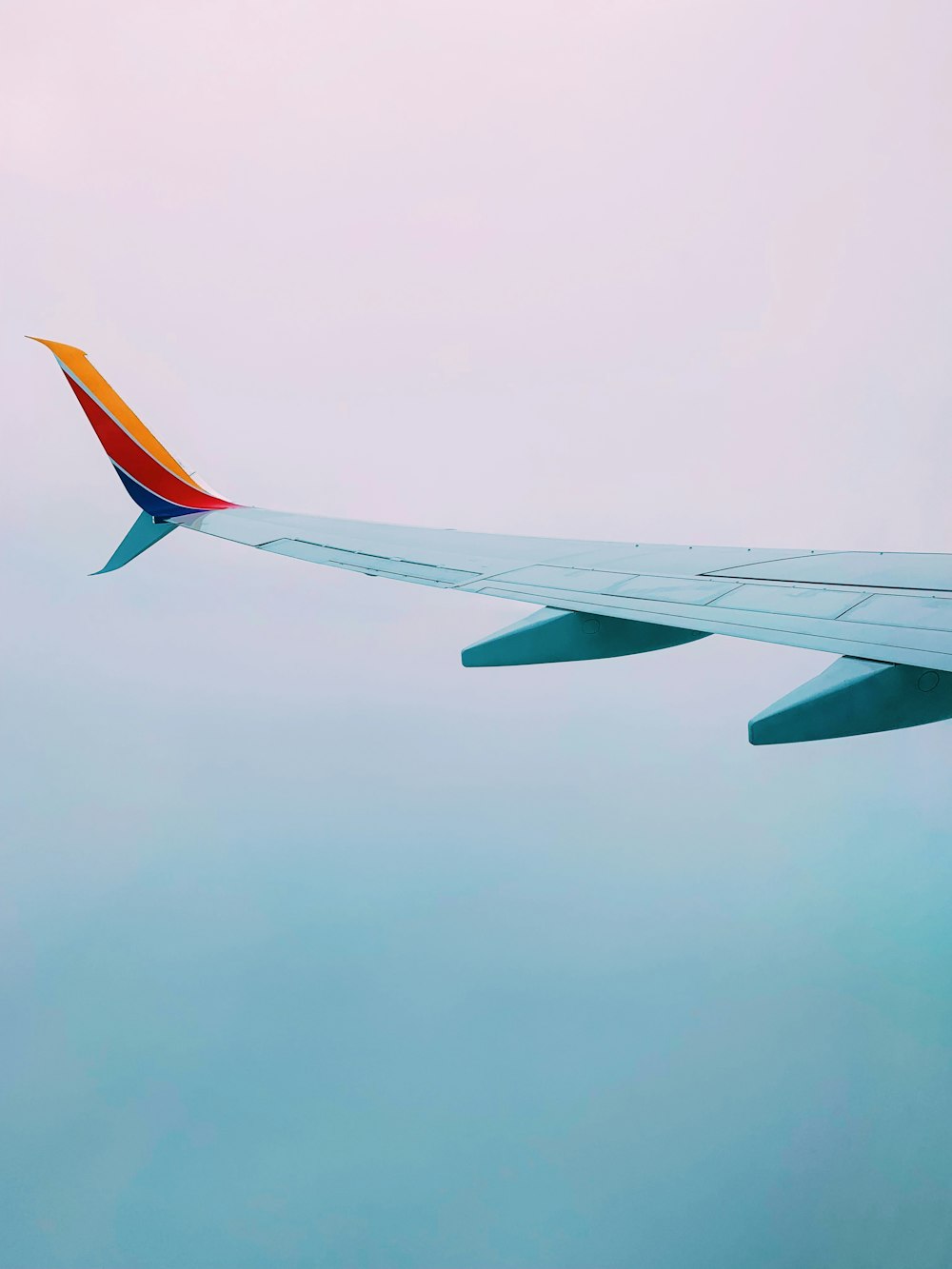 white, red, and yellow airplane wing