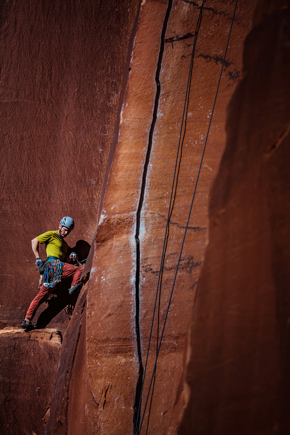 man climbing up a mountain