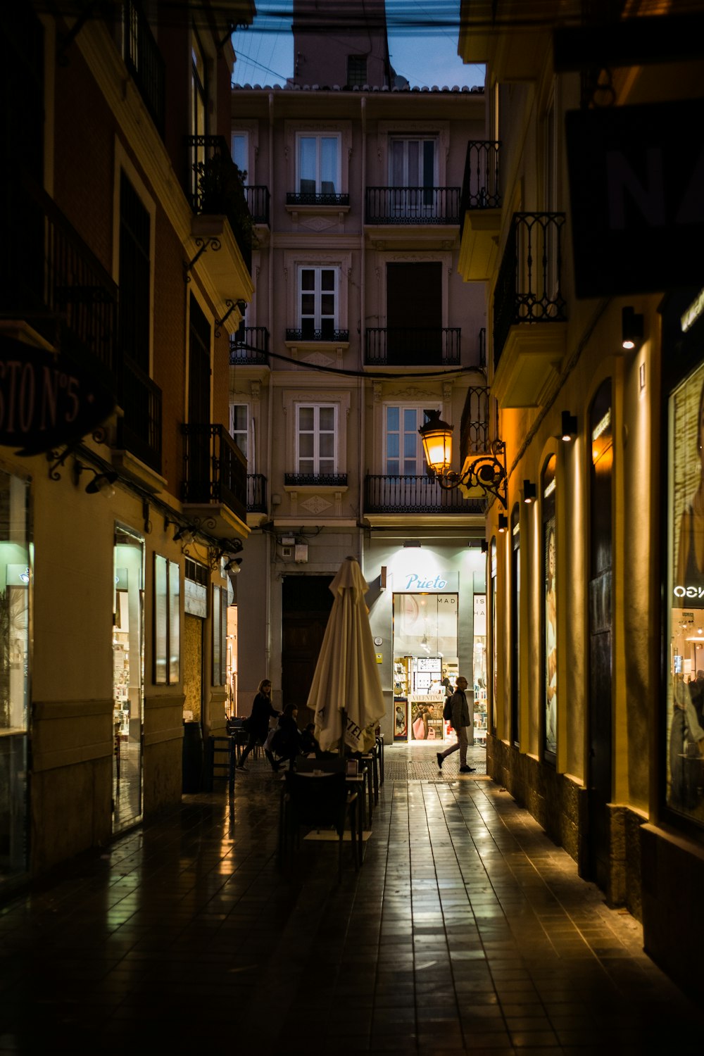 folded white table umbrella at night