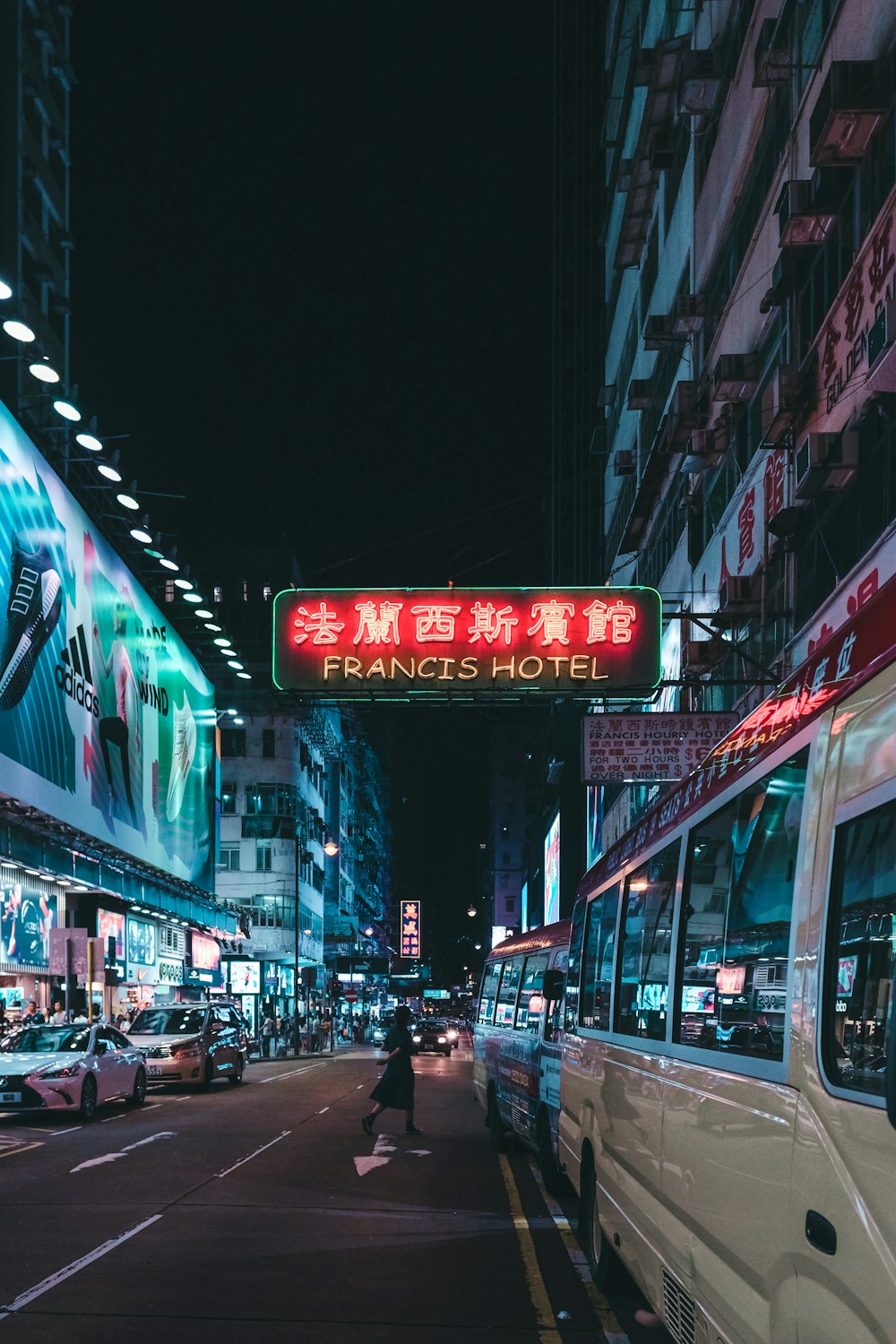 white bus on road near building during night time