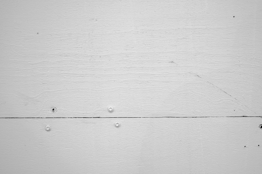 a black and white photo of a white wall