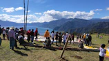Volunteers from the Ensemble list setting up campaign materials under a clear alpine sky.
