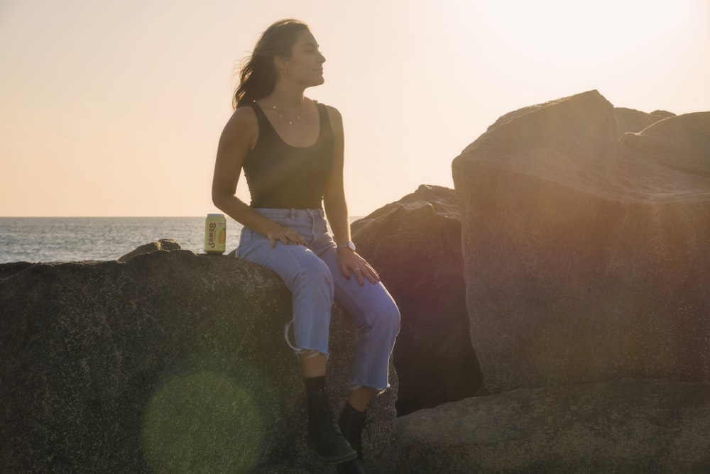 woman sitting on rocks