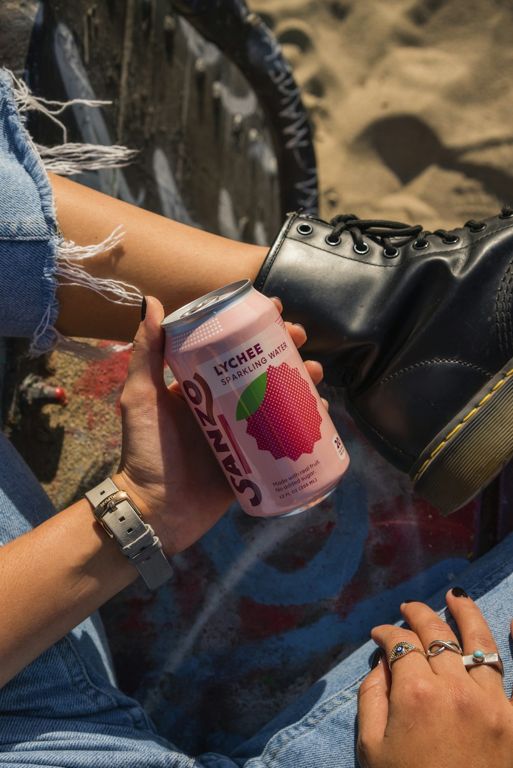 person holding Sanzo beverage can