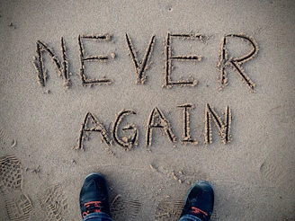 never again sand writing