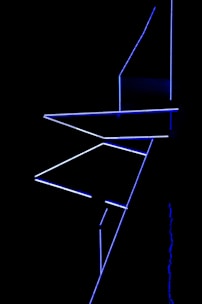 Minimalist still frame from a black-and-white video art piece showing abstract light patterns.