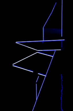 Abstract geometric neon lines forming a network on a black background.