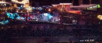 An aerial view of a large festival with crowds and food stalls.