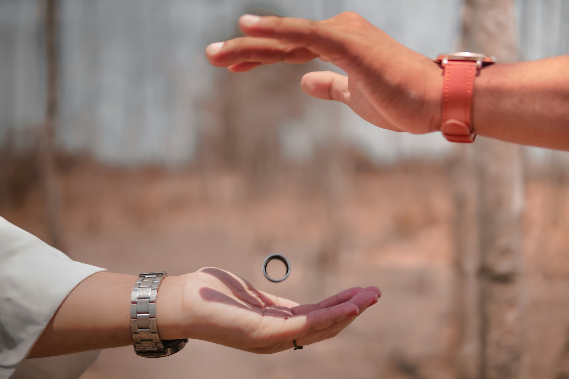 mans hand above women with ring