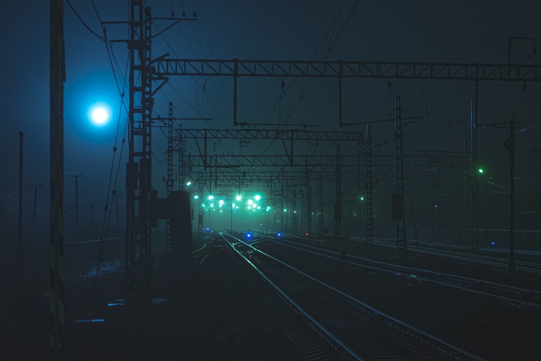 turned-on lamp post at railway