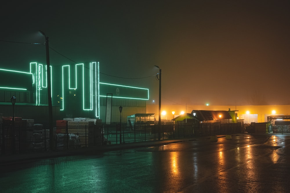 lighted building beside roadway during nighttime