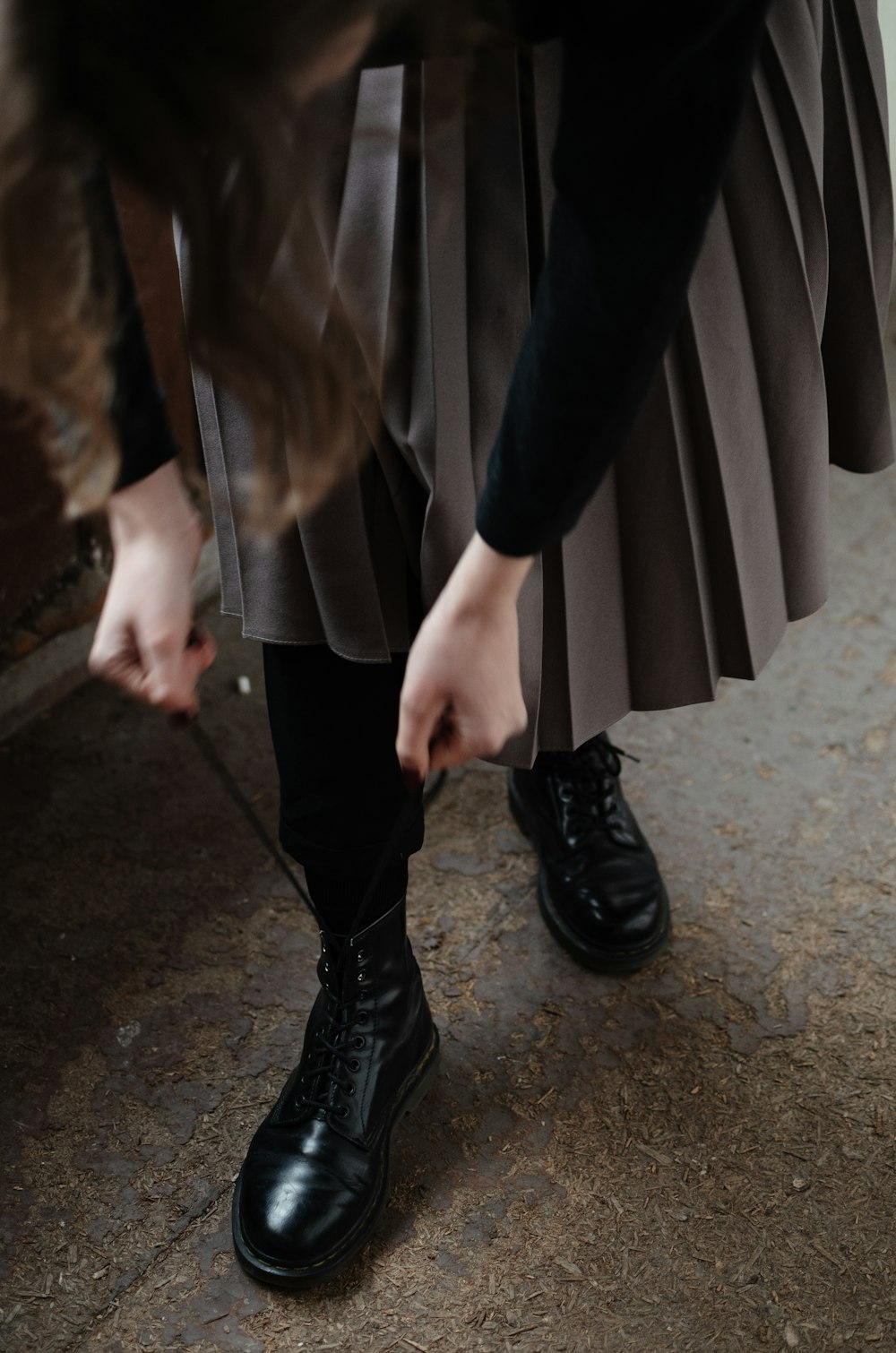 woman holding lace of shoes