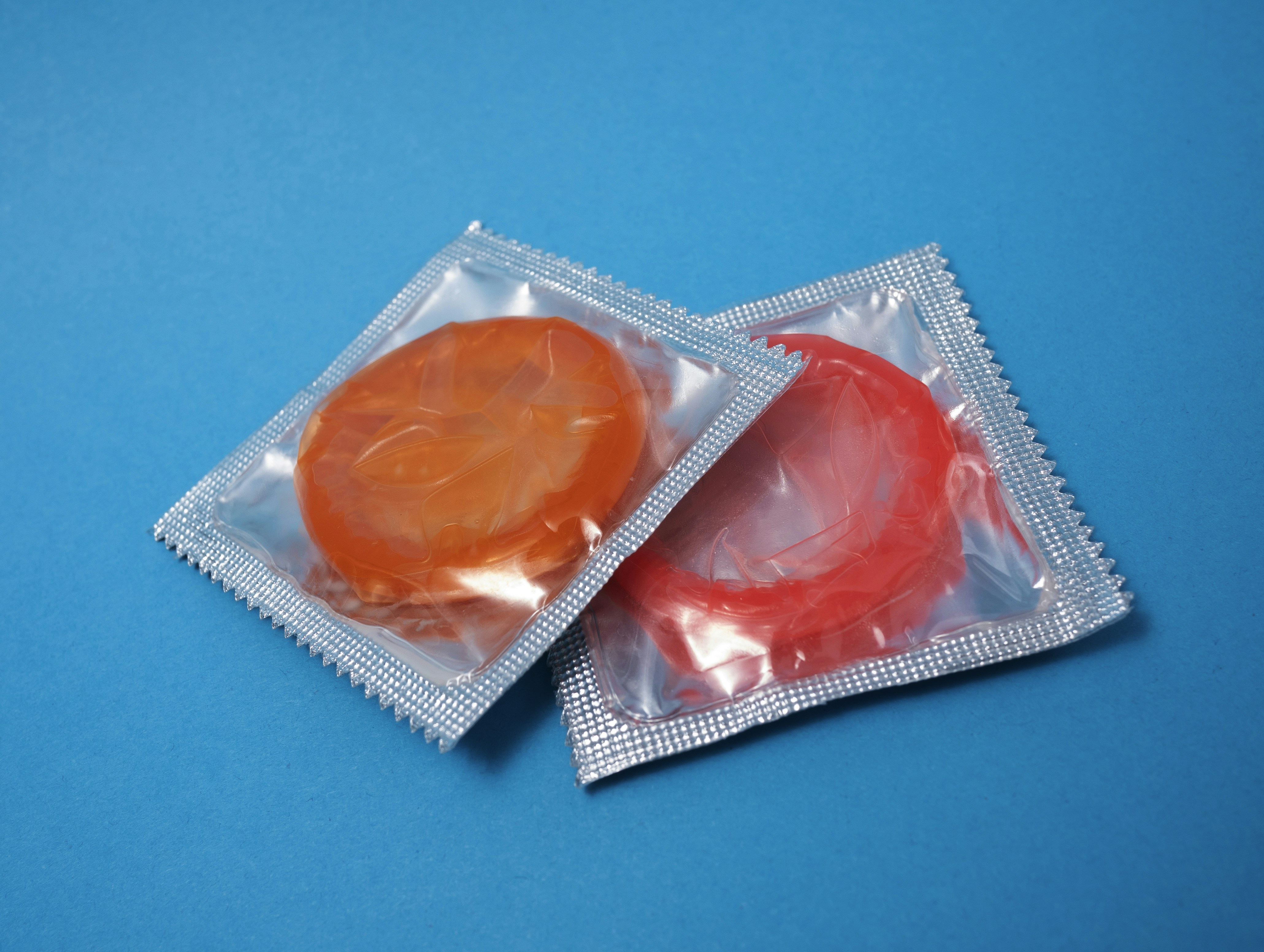 Two condoms on a blue background