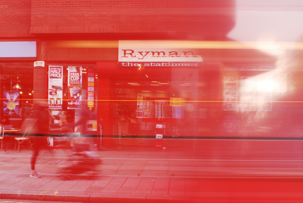 time-lapse photography of people on pathway near Ryman store