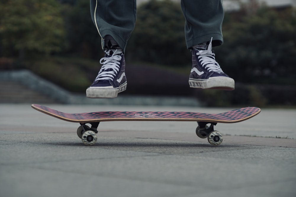 person wearing black-and-white Vans high-top shoes skateboarding
