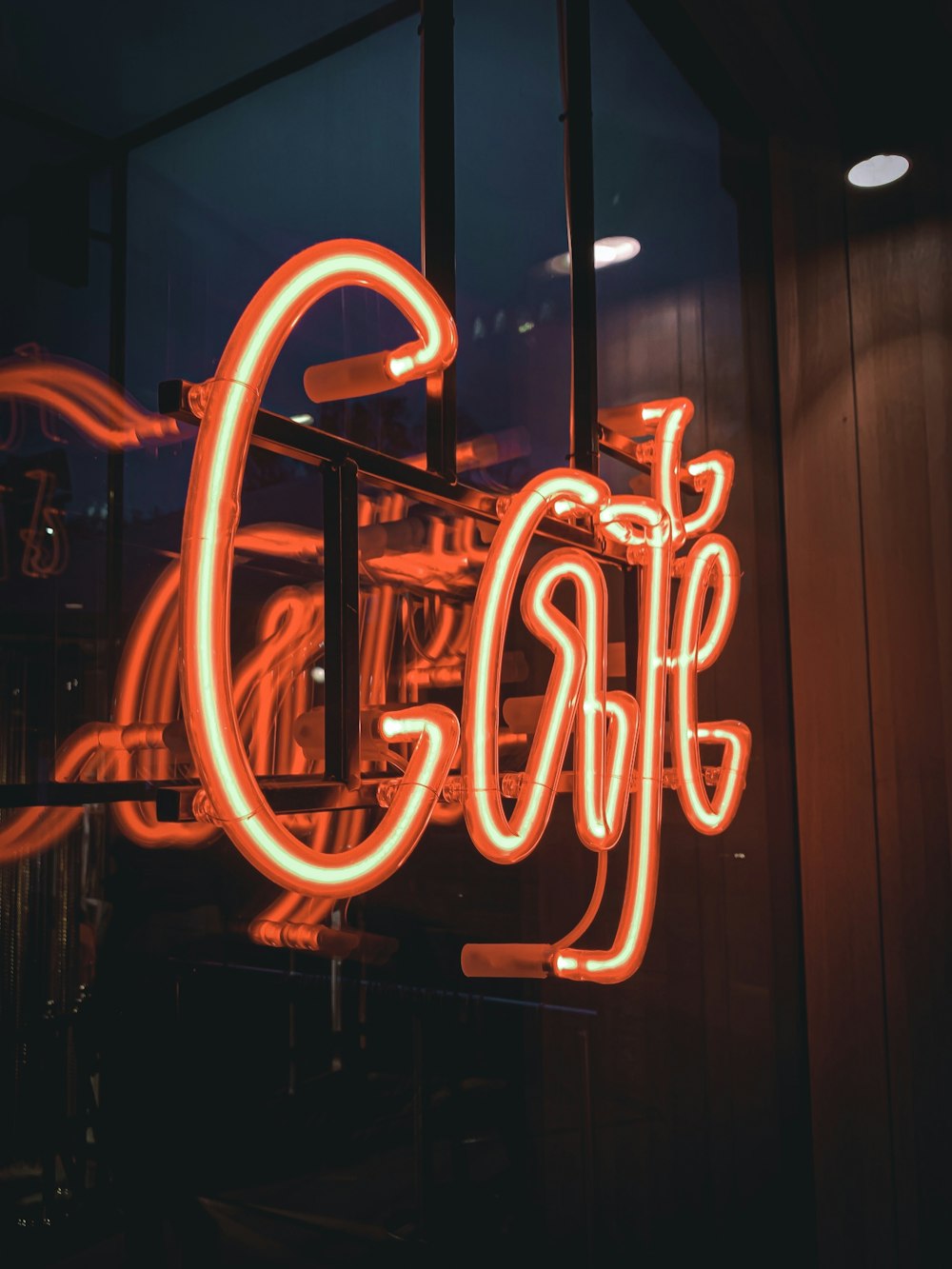 orange and white LED lights on glass wall