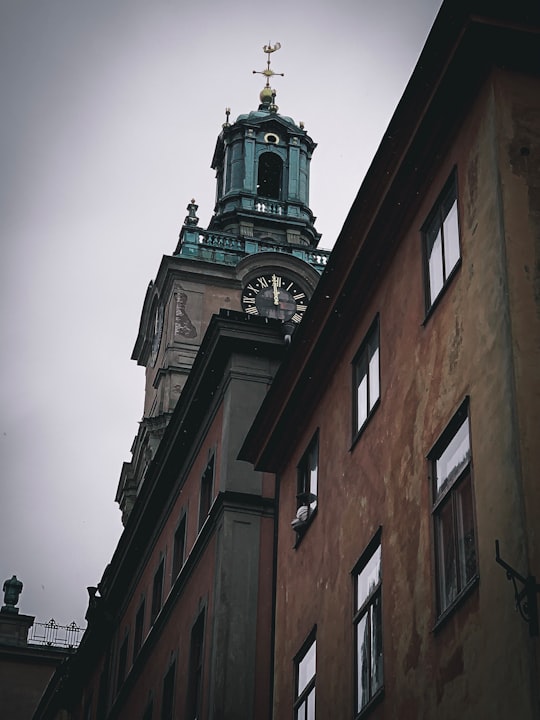 gray concrete tower clock during daytime in Storkyrkan Sweden