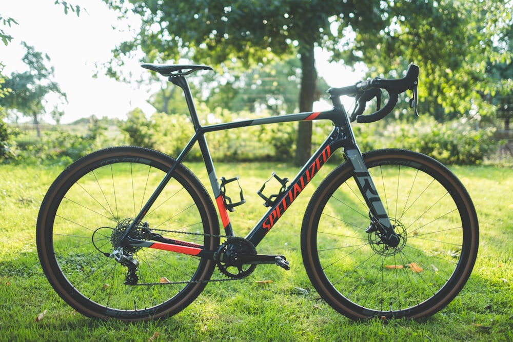 black and white Specialized road bike on green field