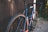 A close-up of a well-maintained road bike leaning against a rustic wooden fence.