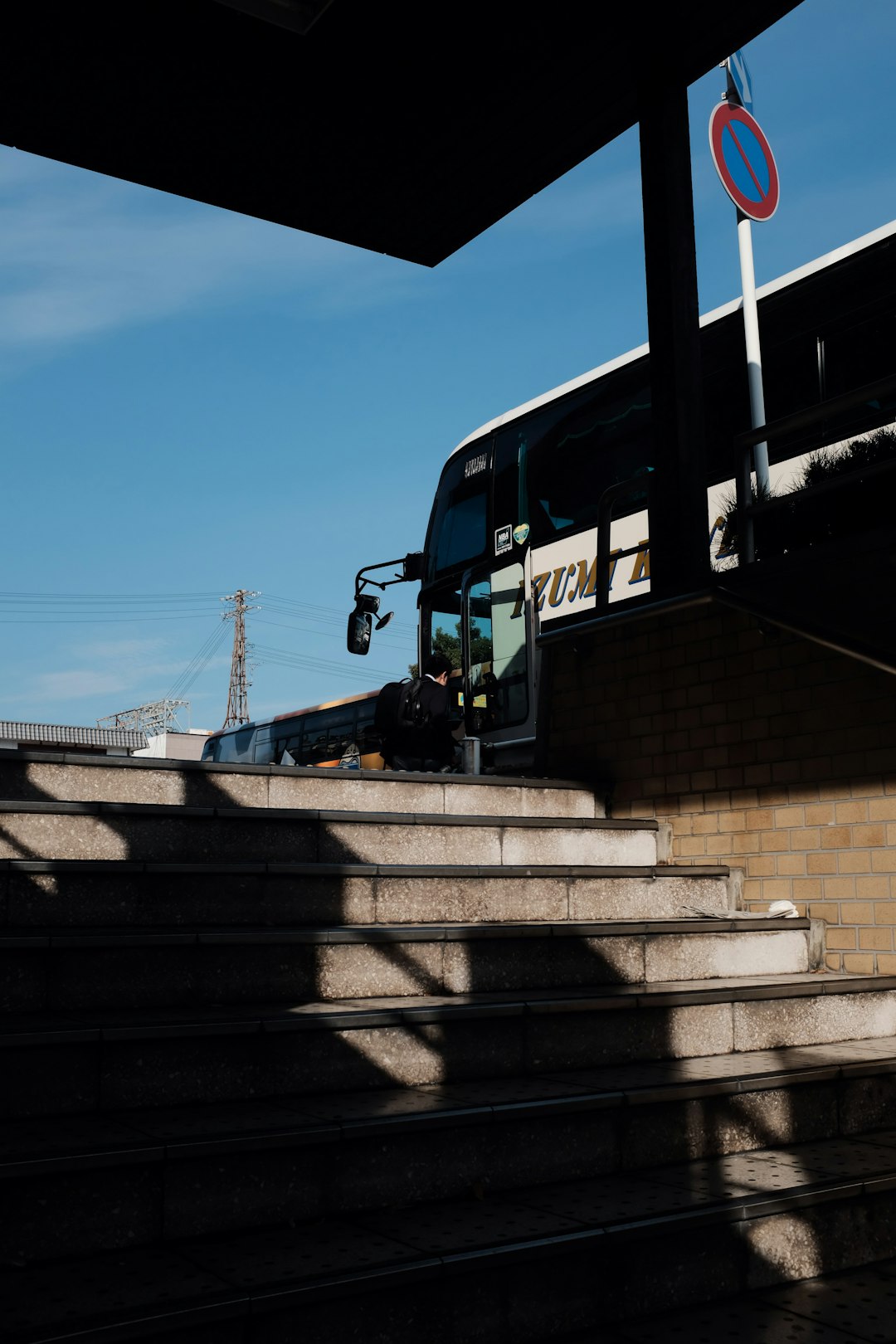 white and blue bus stop near stairs