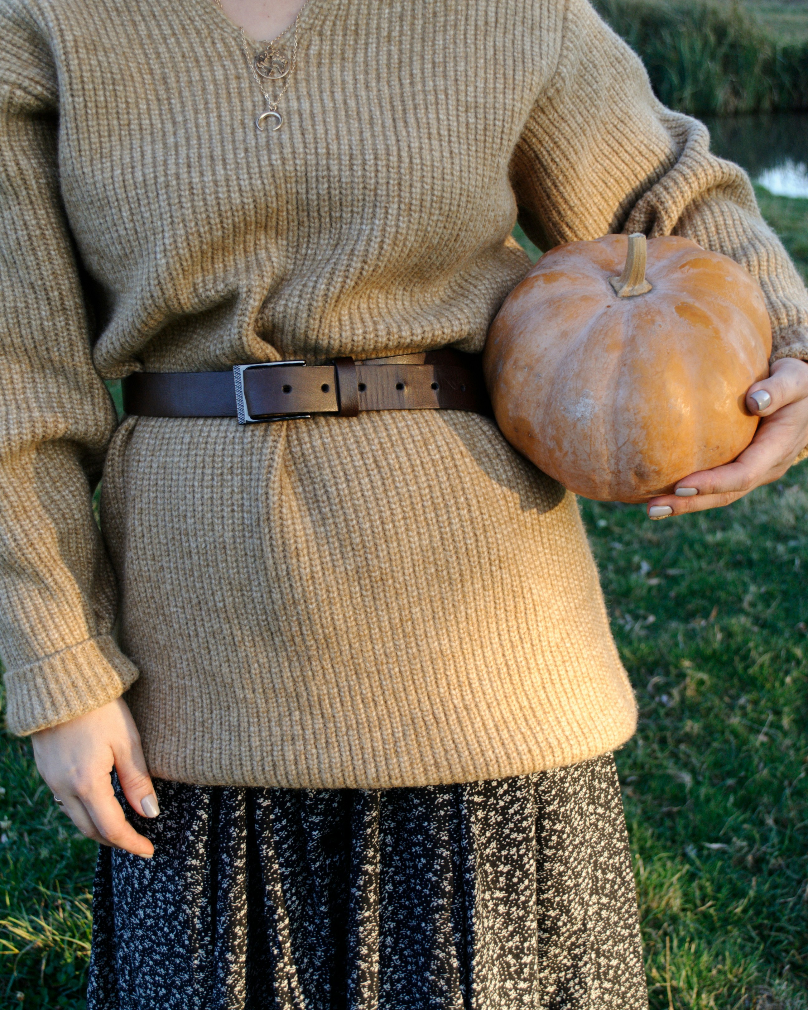 standing woman holding orange squash