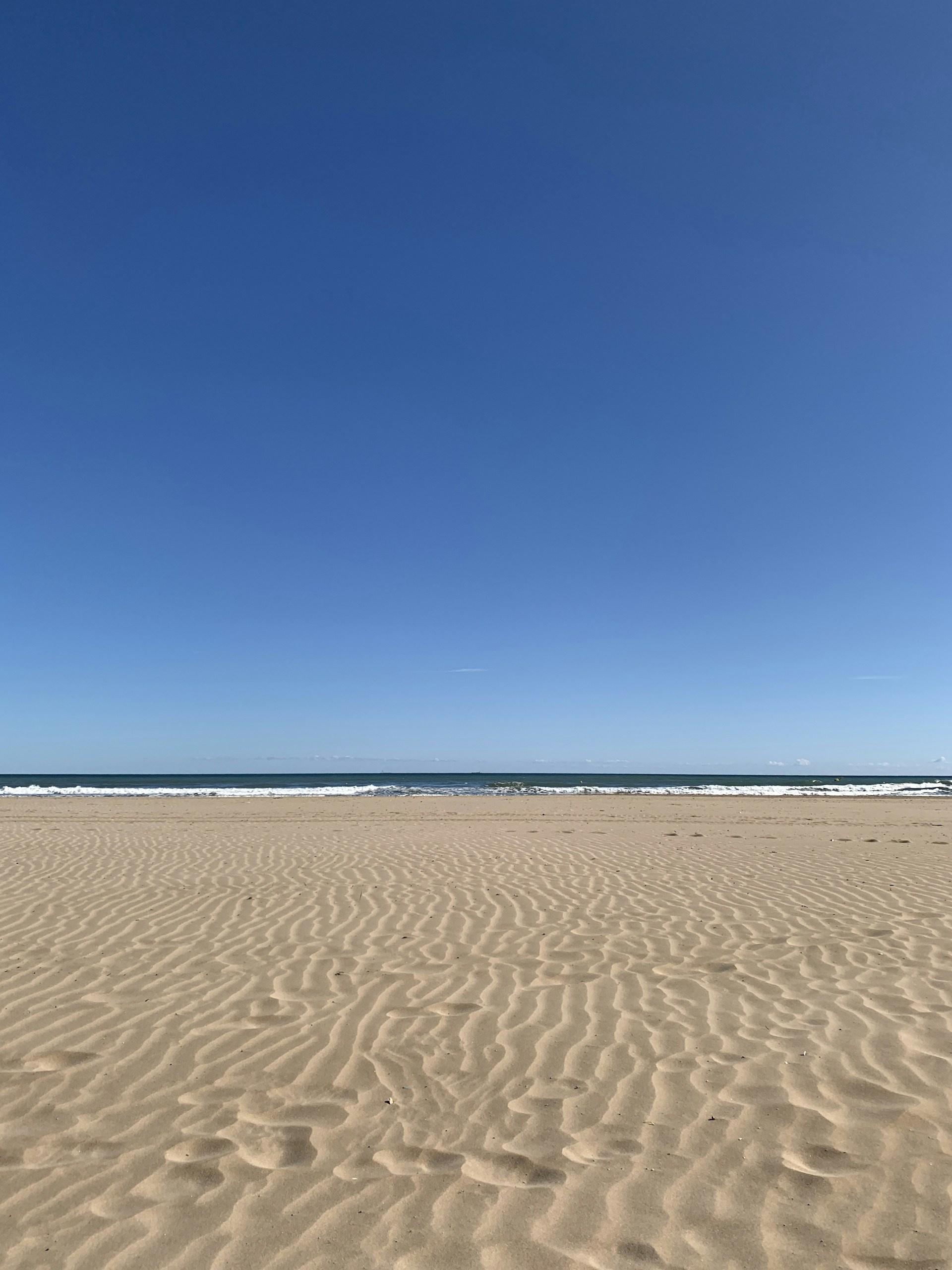 body of water and white sand
