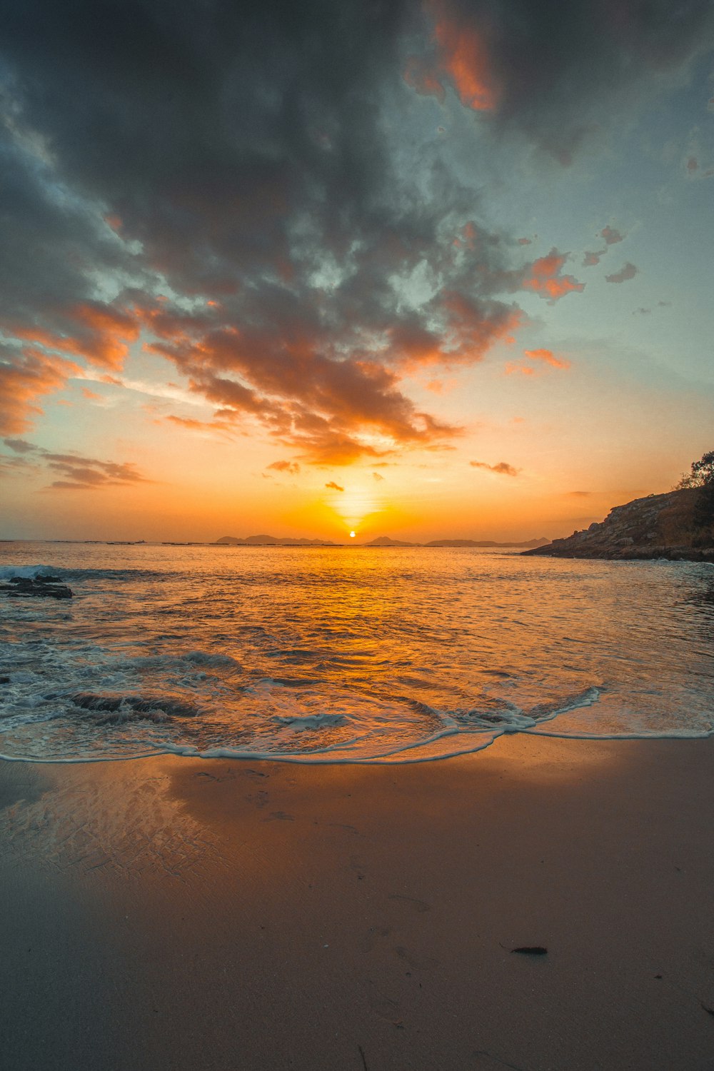 sea waves crashing on shore under golden hour