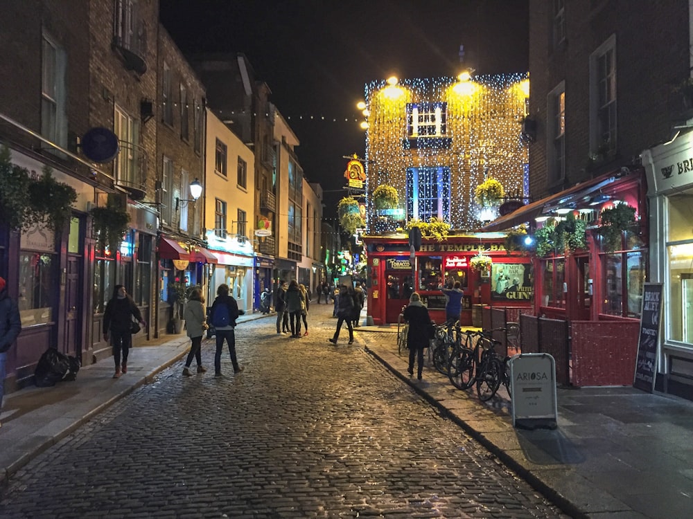 people walking on streets at night