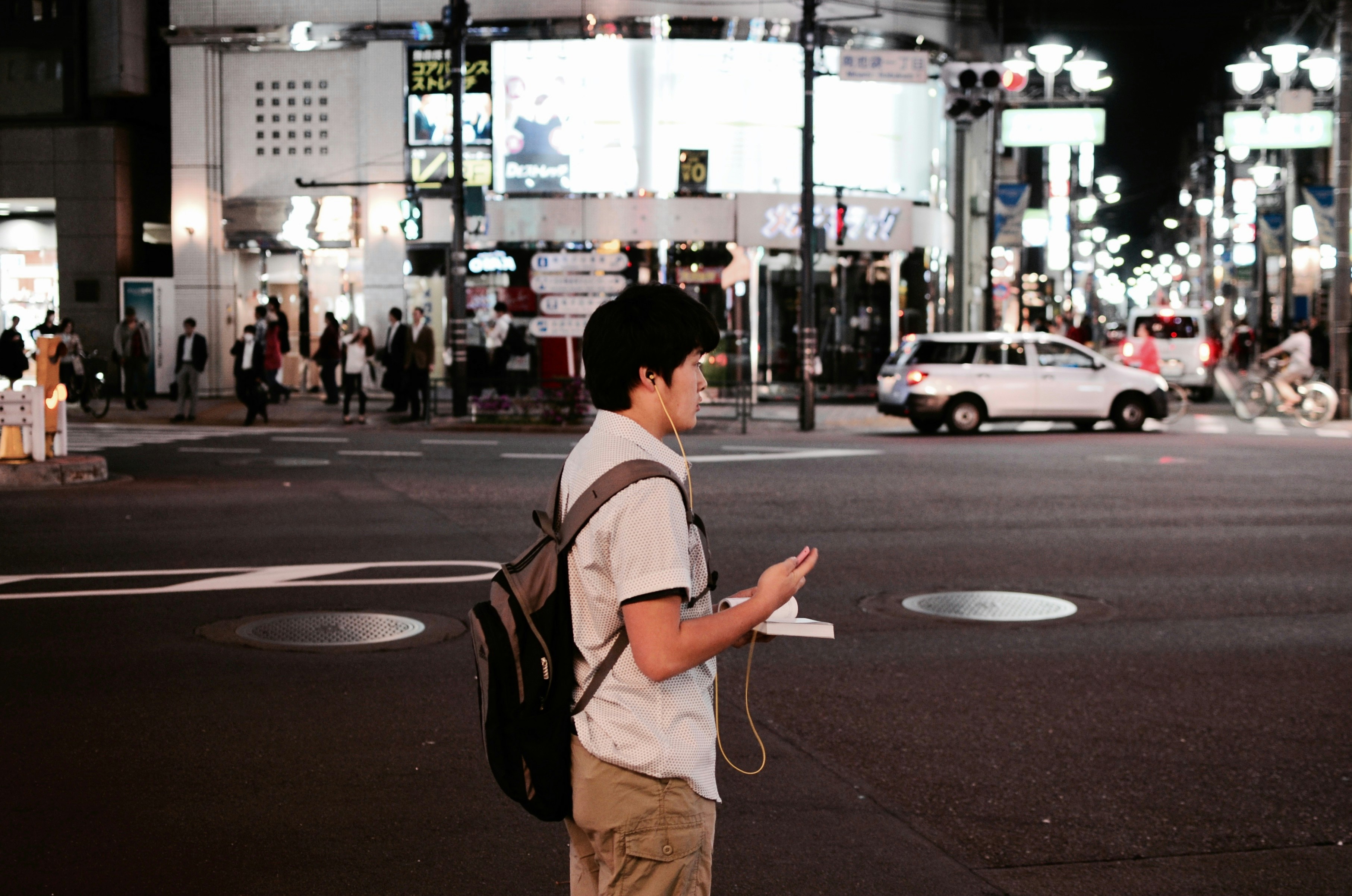 Tourist looking at a map and phone, planning routes in a city