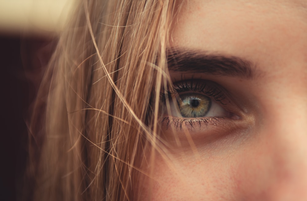 a close up of a woman's blue eyes
