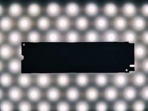 A sleek, high-performance SSD resting on a futuristic circuit board background, glowing softly.