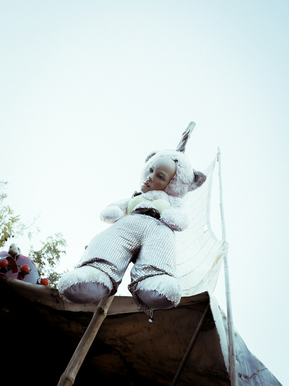 doll hanged on gray stick