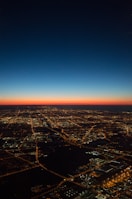 A cinematic video still of a cityscape at dusk with glowing lights.
