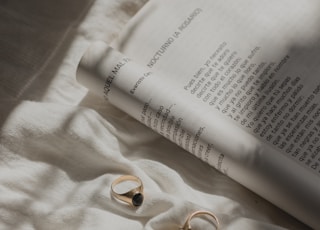 gold-colored rings near open book