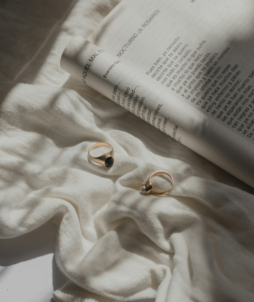 gold-colored rings near open book