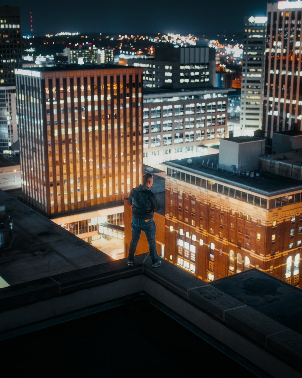 man standing on rooftop