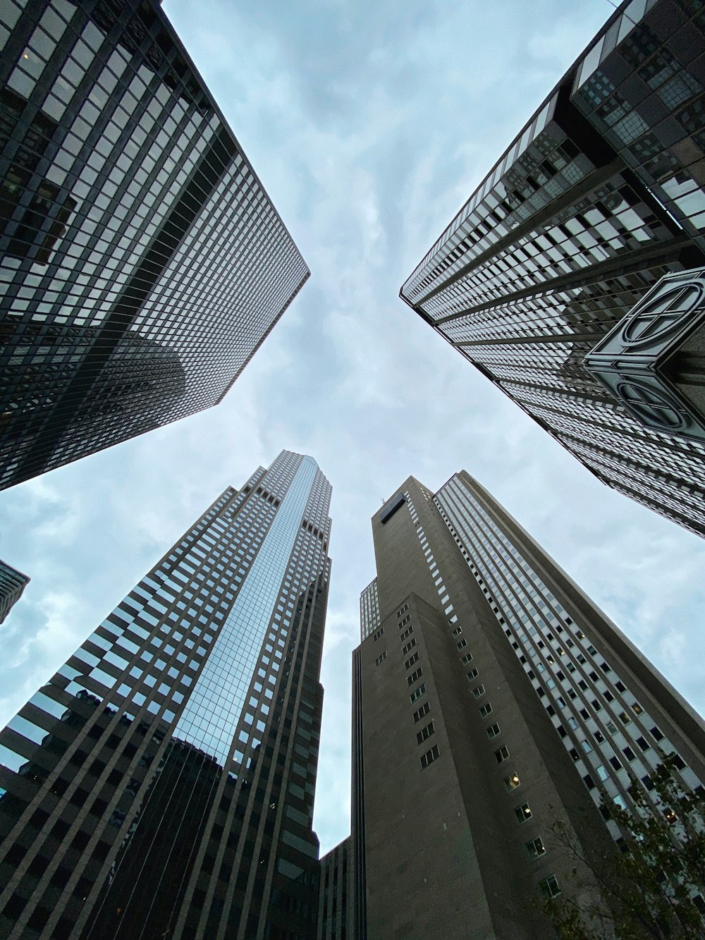 low-angle photography of brown high-rise buildings under blue and white sky during daytime