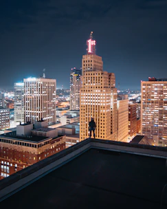 person standing on the edge of the building
