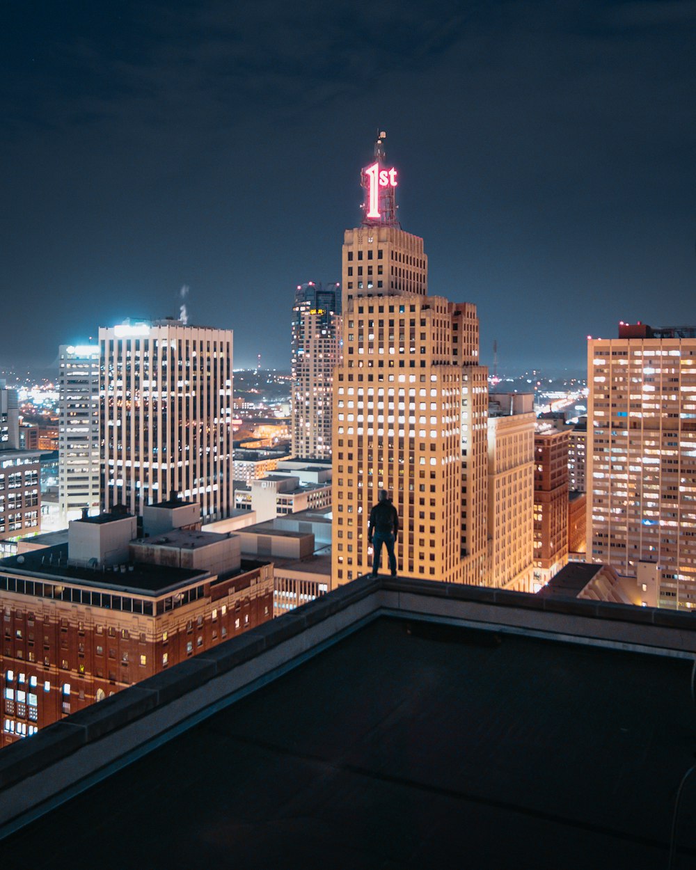 person standing on the edge of the building