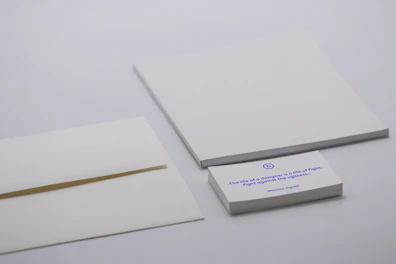 An elegant set of personalized stationery displayed on a clean white desk.