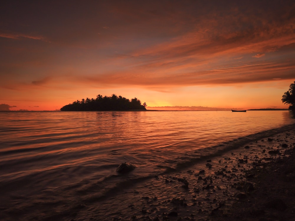 body of water during sunset