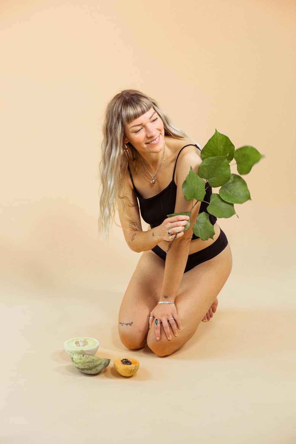 woman holding green leaves