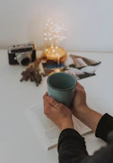 person holding blue mug