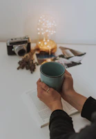 person holding blue mug