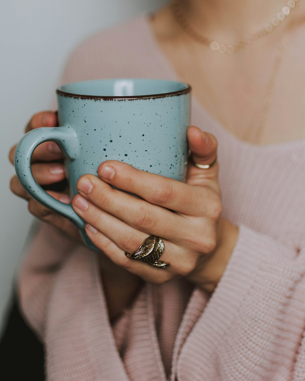 woman holding blue mug