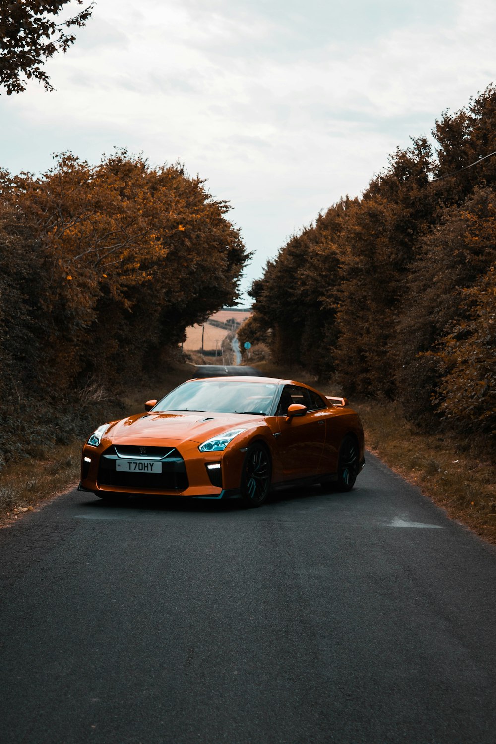 orange sports car on road